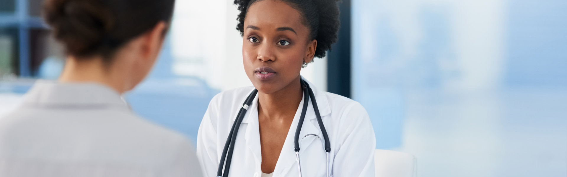 female doctor talking to a patient in her office